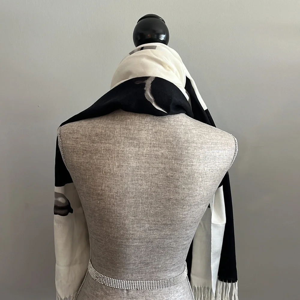 Lightweight scarf/wrap.  Cream and black with floral details.  Fringe on the end